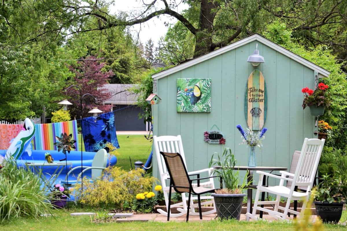 Backyard living space with green garden shed